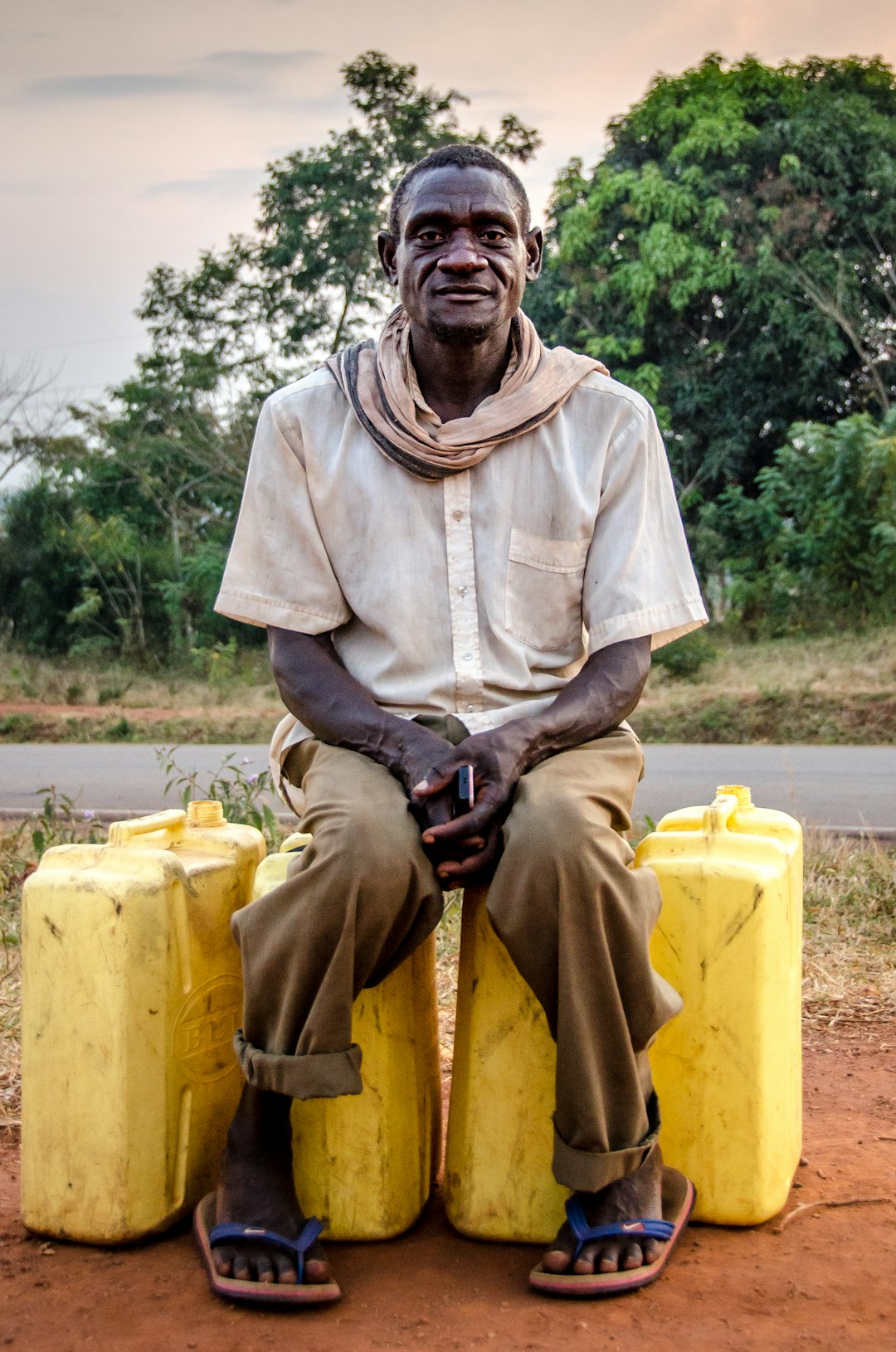 man-sitting-on-yellow-plastic-containers-1porsdcau2k
